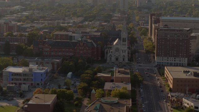 Slow pull away from church at St. Louis University campus in midtown St. Louis at sunset
