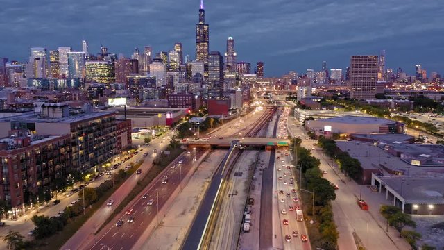 Aerial: The Chicago city skyline & traffic on the 290 Freeway at night. Illinois, USA.
