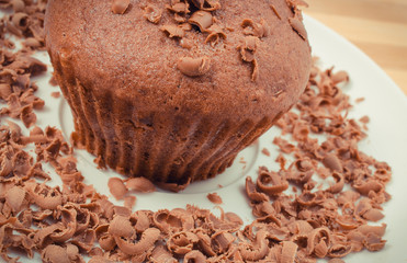 Fresh baked muffin with grated chocolate. Delicious dessert