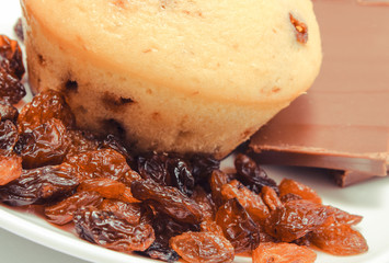 Fresh baked muffins with raisins and pieces of chocolate. Delicious dessert
