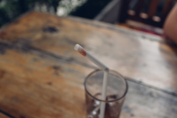 Close up of lipstick on the tip of the straw.