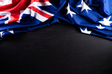 Australia day concept. Australian flag with the text Happy Australia day against a blackboard...