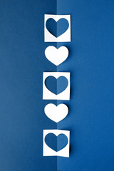 White paper heart on classic blue background. Empty place for copy space for text. mock-up, minimal concept of romance winter february holiday. saint Valentine day