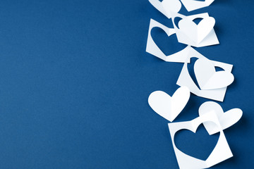 Valentine background with white blue paper craft hearts border on classic blue background, Happy...