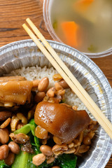 top view pork knuckle with rice as a take out fast food vertical composition