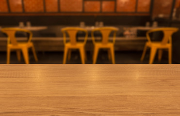 A empty table top wood finishing in restaurant in yellow theme