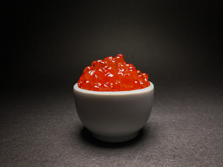 Red salmon caviar. Delicacy. Close-up on an isolated background.