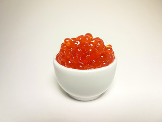 Red salmon caviar. Delicacy. Close-up on an isolated background.