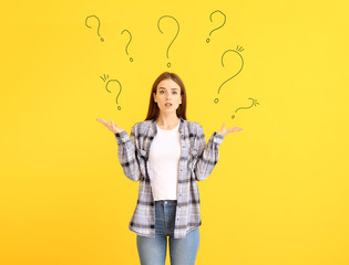 Fototapeta premium Helpless young woman on color background. Concept of choice