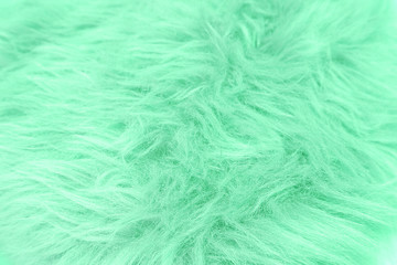 Color trendy background. Close up of fiber soft fur texture Green mint color. copy space