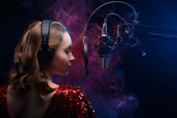 Girl sings into a microphone. Screensaver for a vocal school, work and training in vocals. Singing and lesson in music. Bright background.