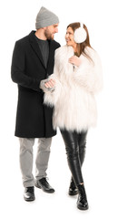 Portrait of happy couple in winter clothes on white background