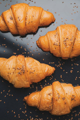 Tasty croissants on baking tray