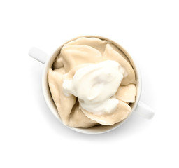 Pot with tasty dumplings on white background