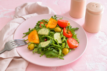 Plate with tasty salad on table