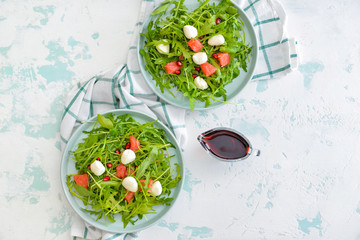 Plates with tasty salad on table