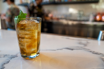 Mai tai mixed drink with mint leaf on bar counter at restaurant