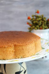 Homemade cardamon and vanilla sponge cake on wooden table with copy space. Birthday cake with copy space