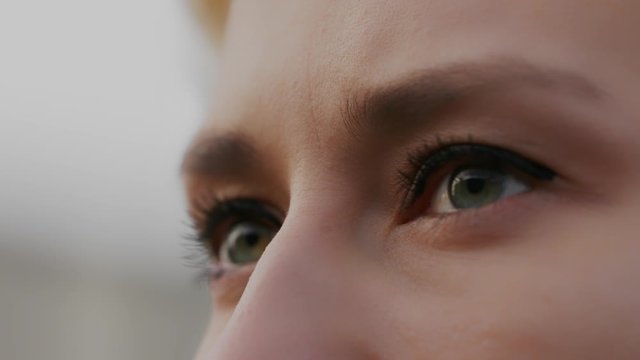 Close up shot of a woman with green eyes and makeup. slow motion shot with shallow focus and copy space. Beauty concept