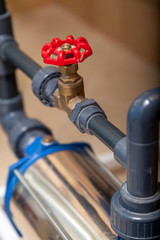 Close-up water tap on plastic pipe