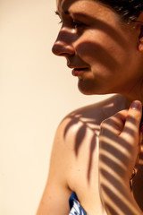 Shadow from palm on girl face in profile