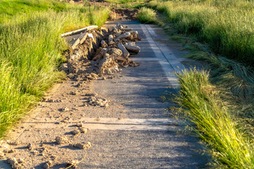 Road construction with damaged concrete paved road viewed on a sunny day