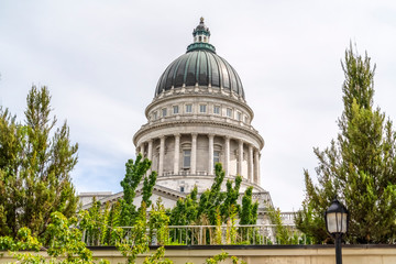 Famous dome of Utah State Capitol Building against cloudy sky in Salt Lake City