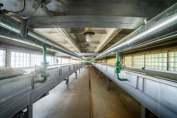 Conveyor belts and pipes, part of chain machinery for disposing and processing waste material.