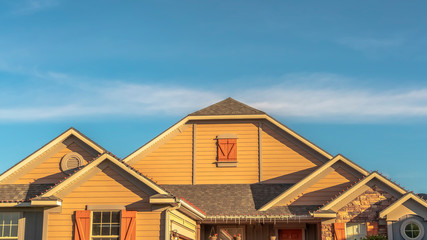 Panorama House exterior with view of the gable roof with gable windows against blue sky