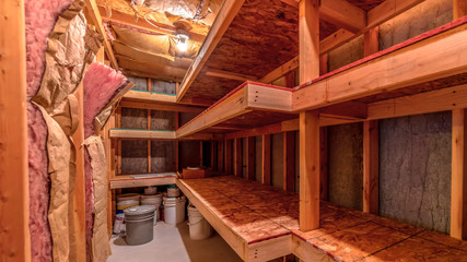 Panorama Interior of food cold storage with wooden racks and insulated wall and ceiling