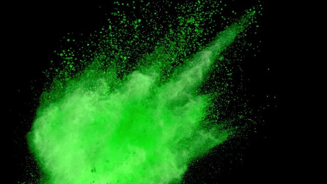 Realistic green powder explosion on black background. Slow motion movement with acceleration from left corner