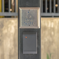 Square frame Selective focus on a handicap push button at the entrance of a building