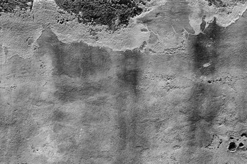 texture of old ruined concrete wall with peeling stucco and dirty drips