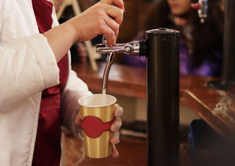 Seller pouring lemonade into a cup