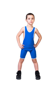  The concept of a little fighter athlete. Little funny boy in a  blue sports tight holding hands on the waist, looking at the camera on a white isolated background