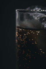 glass of water with ice on black background