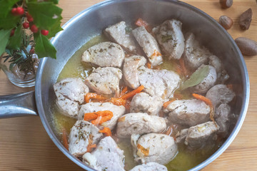 Pieces of chopped meat are fried in a pan