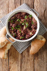 Georgian lobio recipe served with bread close-up in a pan. Vertical top view
