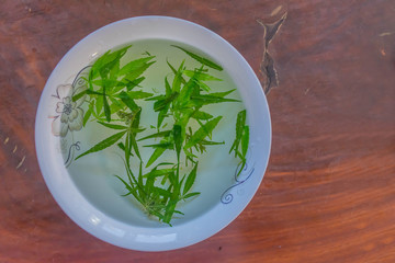 Marijuana herb tea in the bowl.