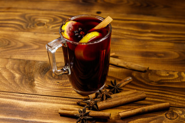 Mulled wine and spices on wooden table