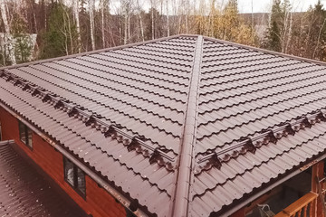 House with a brown metal roof.Corrugated metal roof and metal ro