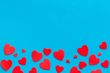 Valentine's Day design. Red hearts frame on blue background top-down copy space