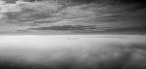 foggy with sky, in black and white