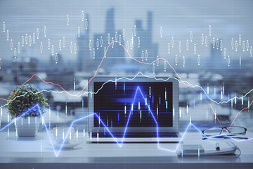 Stock market chart hologram drawn on personal computer background. Double exposure. Concept of investment.