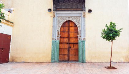 Fototapeta na wymiar Wooden door in oriental style, Fez, Morocco. Copy space for text.