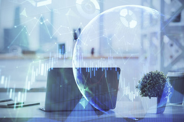 Stock market graph on background with desk and personal computer. Multi exposure. Concept of financial analysis.