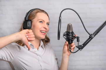 Girl works on the radio or the news. Reads the news in the studio. Radio station and broadcast....