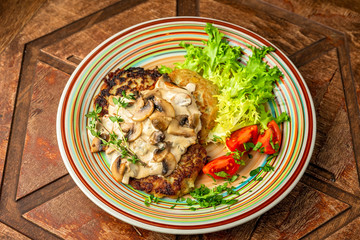 Potato pancakes with mushroom sauce and vegetables