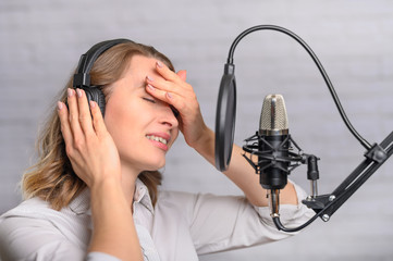 Girl works on the radio or the news. Reads the news in the studio. Radio station and broadcast....