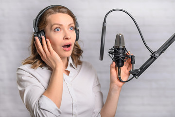 Girl works on the radio or the news. Reads the news in the studio. Radio station and broadcast....